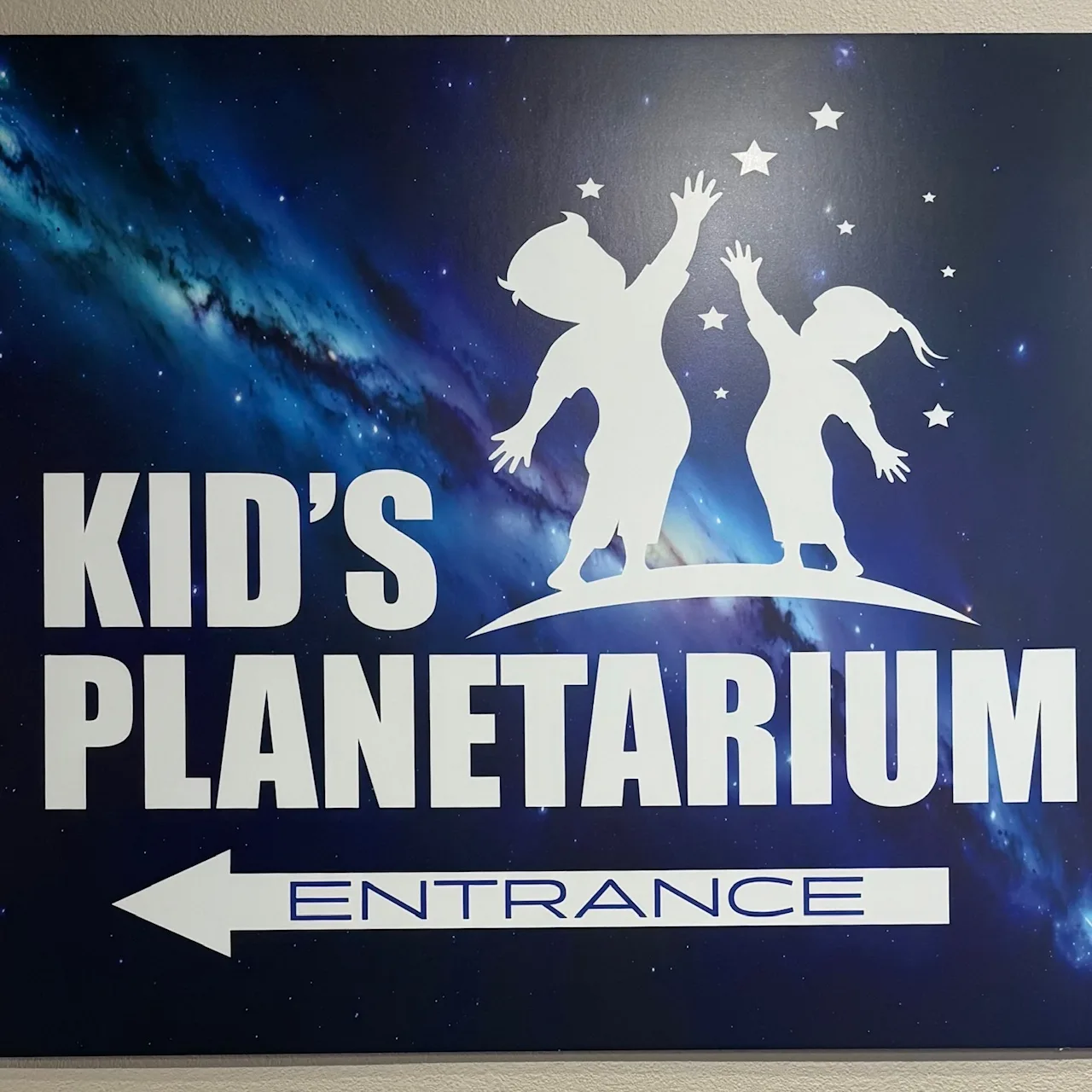 Sign reading "Kid's Planetarium Entrance"