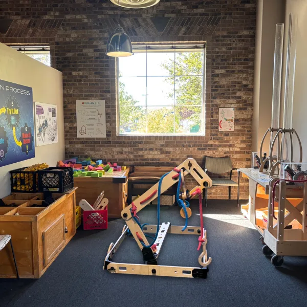 Room with Rigamajig building supplies, foam blocks, and bottle launchers.