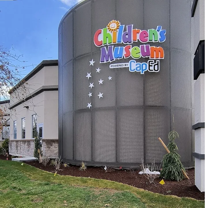 The Children's Museum of Idaho building exterior, a low modern facade with the museum's rainbow sign above the main entrance