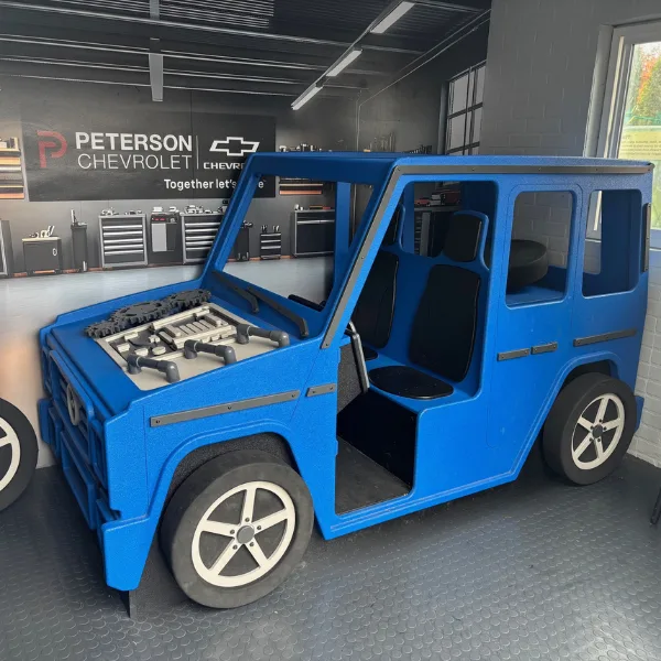 Blue car in a garage that kids can fix up
