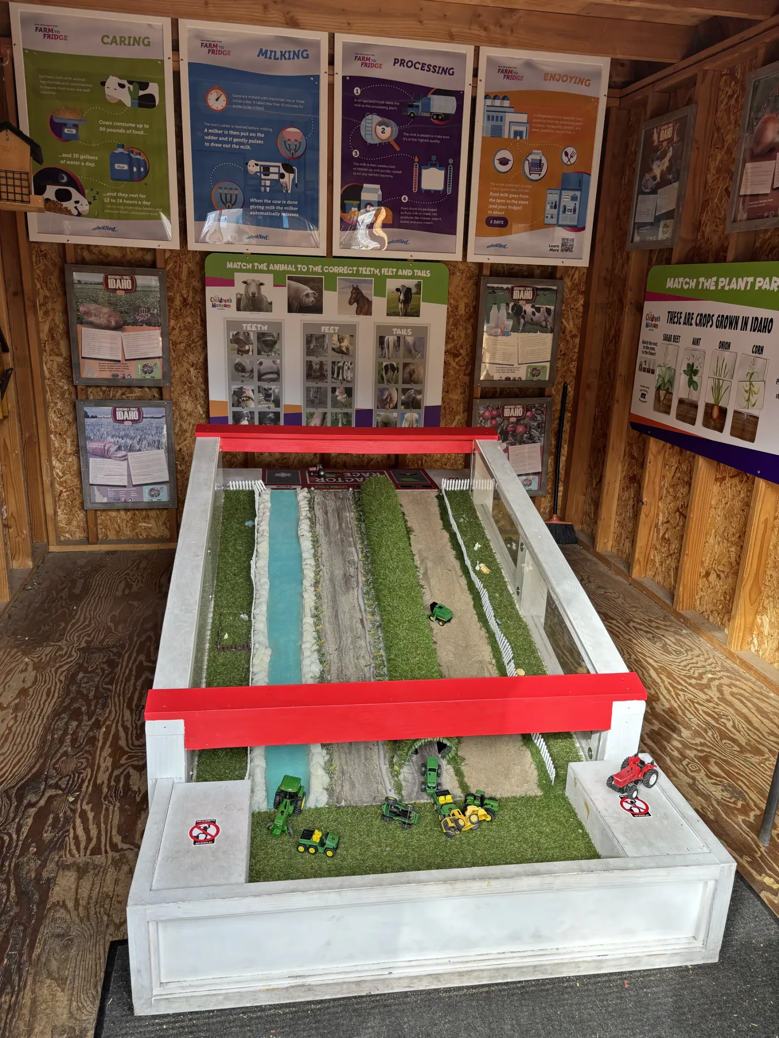The Tractor Run inside Zamzow's Barn: a long ramp painted like fields and a river, with toy tractors at the bottom.